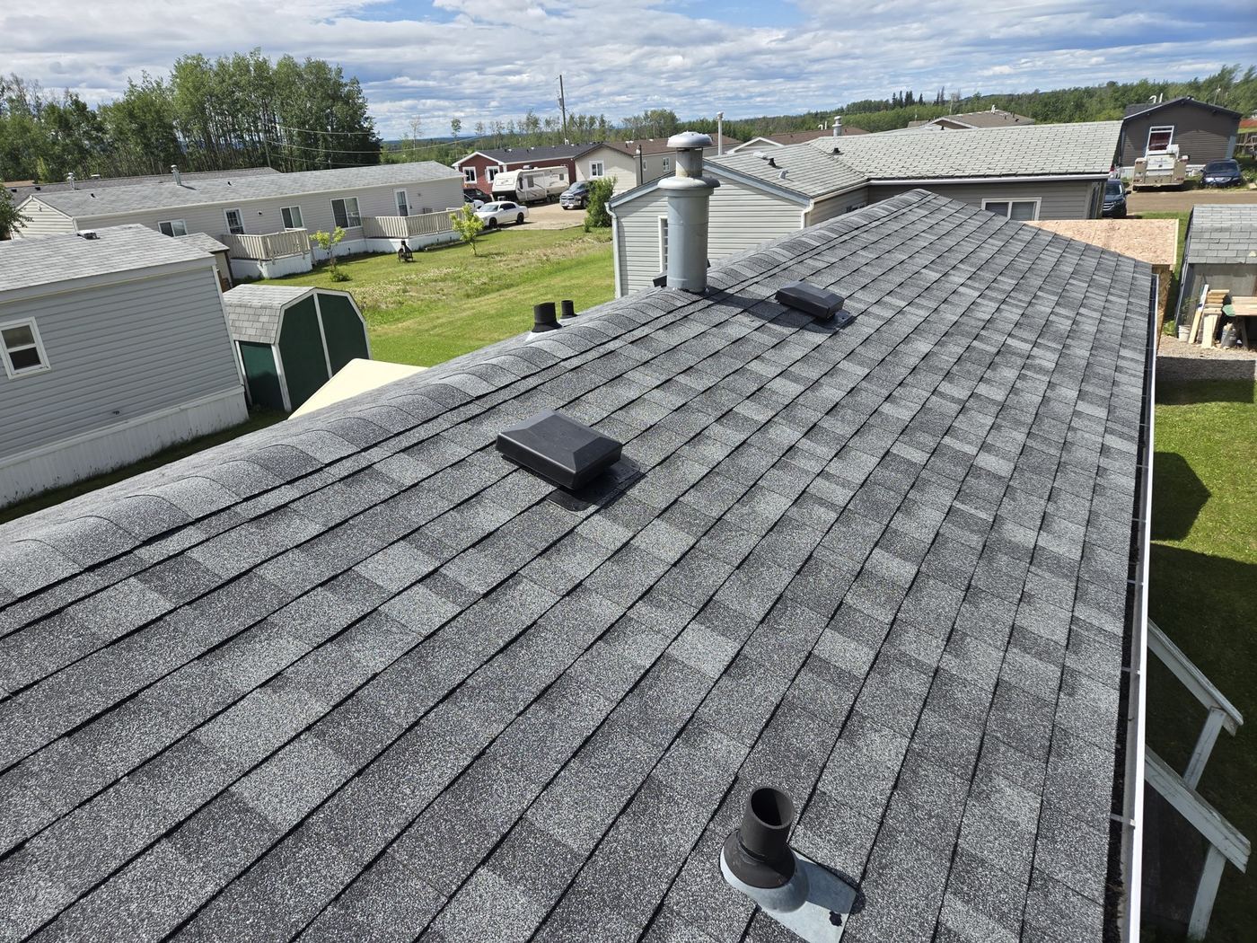 Completed asphalt shingle roof with chimney, Taylor BC · Sunnybrook Roofing