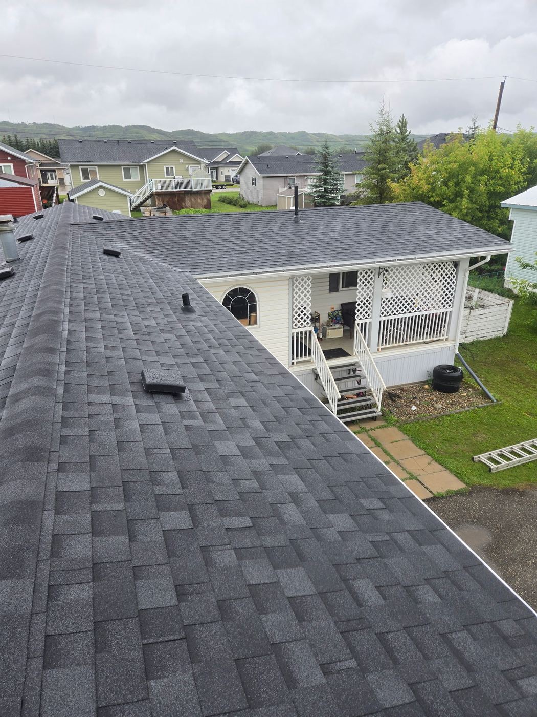 New shingle roof over a covered front porch, Peace Region · Sunnybrook Roofing
