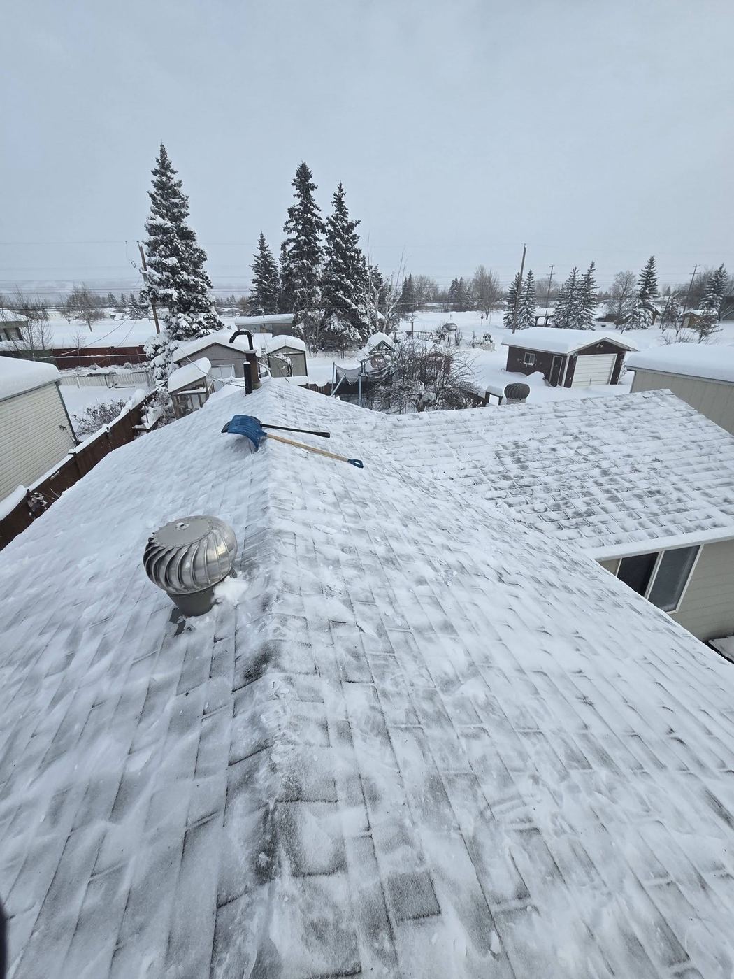 Roof snow removal in progress through a Peace Country winter · Sunnybrook Roofing